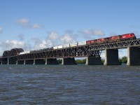 A GP20C-ECO is leading three GE's as a long CP 251 crosses the St. Lawrence river with mixed freight followed by intermodal traffic. Unit numbers are CP 2318, CP 8873, CP 8720 & CP 8136. 