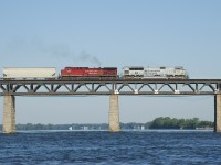 Air Force unit CP 7023 and smokey CP 8620 leads CP 253 over the St. Lawrence River on a gorgeous summer morning.