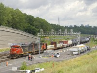 An increasing number of cowls are coming out of the dead line on CN, and here CN 2454 is leading CN 5623 as CN 305 swaps crews at Turcot Ouest, with the sun making a brief appearance.