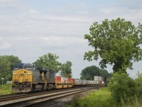 A low-numbered AC4400CW leads CN 327 as it passes through Dorval with CSXT 9 & CSXT 587 for power. Up front are 16 intermodal platforms.