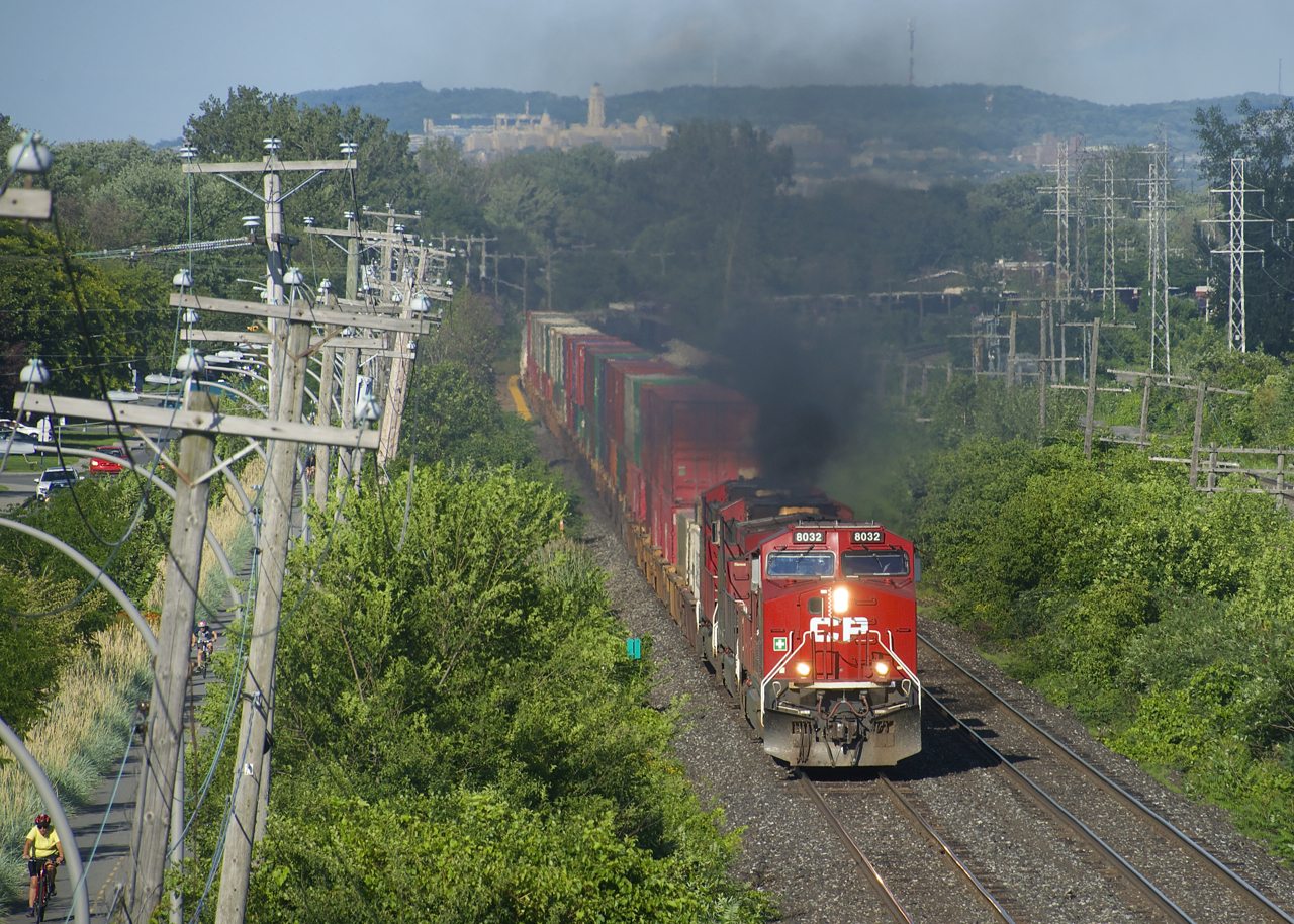 One of the GE's powering CP 119 lets out smoke as it heads west.