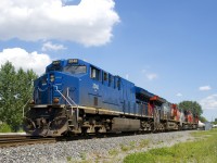 One of a handful of GECX units not repainted and renumbered by CN leads CN 527 as it crosses from the north track to the south track of CN's Montreal Sub on its way to Taschereau Yard with 49 cars. Five more units are trailing: CN 3213, CN 9454, CN 2573, CN 8819 & CN 9639.