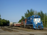 CN 536 with GMTX 2293 & CN 4141 does some switching behind the Coteau Station on a sunny and humid evening. At the head end are covered gons with zinc for a client in Valleyfield.