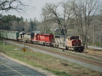 Dock Siding is where Road #612 thru MacTier n/b comes out at main Hwy 69, south of Parry Sound. Hwy 69 can be seen on the right, and 612 on the left in the photo. And train #336 south is taking the siding. What is interesting about this shot is the middle unit.
Back in 1996 CN took over the CP haul contract from Ontario Hydro, which involved a coal run from Beinfait, SK to Thunder Bay. Included in the deal came eleven of a group of CP SD40-2s that were captive to this operation.
They were slotted on CN as 5388-5398. (CP kept the other 5 of the 16 involved). Highly visible to the fans on account their bright red paint; by the time I shot this image in early 2001 the CN 5391 pictured here was the last one remaining. The others were actually sold back to CP in 2000. The CN 5391 (former CP 5782) 
soldiered on until retirement in 2008.
Image shows CN 5274, 5391 and GCFX 6069 (Connell Finance Co) formerly CN 5170..rebuilt and leased to CN.