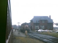 It is a good thing I do not mind crummy day photography. The weather could not have been much worse in the morning of an Ontario Railway Association fantrip to Owen Sound over the weekend of Thanksgiving, 1974. Here we are at Orangeville, in the morning, peering out and rain, mist, and fog. This dreary view shows the resident CP RS-10 awaiting next assignment; the Crew Quarters/restaurant building (destroyed by fire 03/2006) and in behind one can barely make out the old Orangeville station, a beautiful structure which was moved downtown in the 1980s to serve as a restaurant. Note the old lamps along the walkway. Hard to believe, but regular passenger service ended in 1970, only 4 years previous to this image. Save for Trillium moving freight around, all is quiet on the rails here these days.