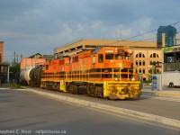 Pass me a beer. While GEXR takes over the GJR in Guelph - I thought I'd post a different GEXR image from the recent past. Here's GEXR  584 shown hitting the 'streets' of the Waterloo Public Square LRT station in downtown Waterloo - passing the Beertown Public House.  A photo that took me a dozen attempts to get with my goal to show the train going by the LRT station in daylight. They usually departed around dusk, but if lucky they would depart rather quickly after going on duty at 1900, if they departed by 1930 you'd get light on the longest summer days, for about four weeks. However, my bets are that it only happened a couple times that summer. Here's one of them. 