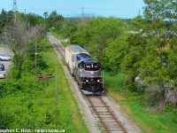 While on a 2 week vacation, I took the time to finally cross the Barrie Collingwood Railway off my list. Here's a heavy train coming from Utopia off the Meaford sub about to cross under the 401 in Barrie. Branchline railroading at its best.