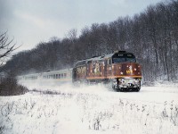 Oh, park the car and trudge thru the snow up onto the CN right-of-way in a most bleary damn cold windy day and this is what I get for a reward. The Loto Quebec paint scheme on eastbound VIA #72. This warp adorned this unit 6414 from July 2006 until at least 2011.  Yet I very seldom got to photograph it. I guess it was just as well, as I considered this wrap hideous. This was the best they could do?  Seems I am not alone in my thinking, as I  have heard this was so poorly accepted the scheme isn't even available to modellers.  At least it makes for an interesting photo as it kicks up snow on the long grade down from Copetown.