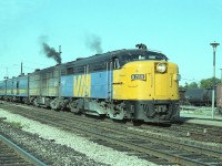 It is a beautiful day, a Thursday afternoon and because it is a weekday VIA's 75 westbound is not all that big. Just 8 cars. This scene is at the old Freeman Station at Burlington West, and the train is stopped to take on passengers. Behind VIA 6789 is 6867. The leader retired by 1989. Don't know where it went. Scrapper? At least the 6867 was saved. It went to Danbury, CT rail museum.