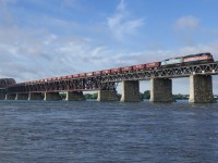 Still together in work train service, CMQ 9017 & CMQ 9011 lead CP GPS-03 over the St. Lawrence River. Up front are loaded ballast cars picked up from the VTR interchange at Whitehall and behind is mixed freight from Saratoga Springs.