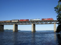 A trio of GE's in two paint schemes (CP 8148, CEFX 1002 & CP 8014) leads CP 251 as it approaches dry land.