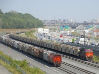 CN 731 has 252 empty potash cars (along with GE's CN 3022 up front and CN 2957 mid-train, for a total of 1,020 axles) as it approaches Turcot Ouest where it will get a new crew.