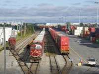 CP 112 has finished yarding the intermodal portion of its train as an employee puts a blue flag on a cut of cars at right. At left are the mid-train and tail end DPU's (CP 8754 & CP 8519), which will soon be added to the head end. Once that is done, CP 112 will head to St-Luc with the non-intermodal portion of its train (mixed freight followed by autoracks, which had been on the tail end).