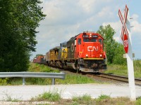 With a friendly wave from the hogger as an eastbound passes a rural crossing in the countryside east of Sarnia with a gaggle of 'if any of this led, that would be great' for motive power.
<br><br>
I usually plan my Sarnia visits quite meticulously, and after having told friends the day before I had no plans to go to Sarnia until the fall... My wife basically presented me a choice - go to the beach in Port Elgin (2 hours each way with nothing in between. UGH). So my rebuttal was if we're going to drive that far, let's just go to Sarnia and bring the kids to visit your parents instead. Check and mate. However, I had to explain to friends that "I'm not going to Sarnia, Hey, I'm in Sarnia" which they just make fun of me for now :)  Thanks to Tim Stevens I was able to intercept this en-route, back when the GECX and other leaders were prevalent, and just about anything would be found leading CN trains..<br><br>So I have zero regrets for this trip, for it was productive. Other than the family functions,  I'd also capture a GECX (YN2) in the lead twice, a pair of GTW's on the Terra, and pair of GMD1's passing each other by the roundhouse. More to come.