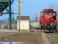 With the tail end of the train framed in unloading equipment at FS partners in Ayr, the end of the pit spur is just beyond the train near that farm. I drove into the FS partners facility in Ayr as they were lifting a cut of cars and found this scene.  Here's some info on the <a href=http://www.trainweb.org/oldtimetrains/CPR_London/ayr_pit.htm target=_blank>Ayr Pit Spur</a> but did folks know that the nearby town of Wolverton, just to the west near Drumbo had a similar spur that followed the river to a mill? Long gone, you can't even tell it was there. 