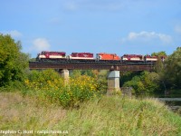 MLW's return to the Guelph Subdivision. OSR's hospital train with CN Engineer Chris Widmeyer at the throttle is seen passing over the beautiful Grand River Bridge in Breslau with the hopes of making it to Salford, Ontario.<br><br>Nothing ever goes according to plan. At the last minute CN was ready to do this move after waiting almost a month. Surprise was they wanted to do it without a CN leader. CN Crew was ordered 0600, but there was a paperwork snafu, no paperwork for the consist. First delay. CN made paperwork and gave it to the crew by 0900 who then made it over to Guelph in a Taxi. OSR had attached their SBU earlier in the morning, but CN could not get it to work. (Second delay). Since that didn't work, they had to go grab another SBU from 542 to test it, which took 30 minutes (Third delay), and that didn't work, so the train was now limited to 15 MPH on the mainline (Fourth). You can see it's already getting quite bad. However, after the train went to the Junction (with 542 pushing on the rear) and was about to go on the main, they called foremen who told them more delays were pending. So it was time to tell this to the trainmaster, and the crew called the RTC to re-lay information  to the CN Trainmaster. This is exactly what was heard over the radio. "So your IDU is not working, you are delayed by a foreman for 30 minutes, and after that you'll be delayed again for 60 minutes for another foreman, and you want me to tell this to the trainmaster, over?" At this time it is 12 PM and the train's supposed to go to London with a crew who was ordered at 0600<br><br>They only made it to Kitchener. <br><br>Lastly, here's <a href=http://www.railpictures.ca/?attachment_id=17812 target=_blank>GEXR (1) </a> <a href=http://www.railpictures.ca/?attachment_id=32307 target=_blank> Shots (2) </a>from the same bridge which also link to Arnold Mooney and Glenn Courtney photos from decades passed. I still haven't done a proper CN shot from this angle. I'll remedy that soon. I would have never guessed I'd get OSR here... ever.