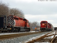 Crew from a rail train wave at the crew of T72 as they exchange pleasantries meeting on the CPR Waterloo Subdivision just north of the Highway 24 overpass. A rare place for two trains to meet, but the work train basically ducked out of the way on the CNR Fergus sub to meet T72 as they had to work on the Galt. The Fergus sub from Concession ave to the switch pictures here is leased by the CPR, and CNR has access to the BWXT tracks (at right) to serve as a customer, but they have yet to do so since GEXR left town.