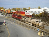 CP 143 has military unit CP 7021 and class unit CP 7000 for power as it backs into Lachine IMS Yard to lift intermodal traffic on an intermittently sunny afternoon.