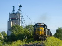 CSXT B786 is passing Dundee Feeds In Huntingdon a bit before sunset. Soon it will back three hoppers towards the mill.