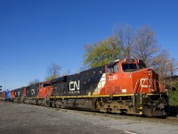 The engineer gives a wave as CN 368 passes Coteau Station. Power is CN 2285, CN 5684, CN 5776 & CN 8952 in fresh GT paint.