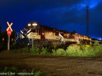 "White meat or dark meat" is heard over the radio as an Ontario Southland Railway crew prepares to get dinner at the local swiss chicken establishment, a stones throw from this location. A storm is quickly brewing in the distance as I set up for some night photography after a long day of work. Having found this train late in the evening, in Guelph, which itself was unusual, I was hoping to capture something dramatic. Little did I know that a storm was also brewing on the O.S.R. and this night was the first hint of it.<br><br>As the winds picked up and thunder grew ever closer, I frantically painted light over my scene as multiple timed exposures rattled off..<br><br>This was no ordinary train, service had basically melted down due to too much work, a third crew was called to combine both trains and finish working the customers. After grabbing a well deserved meal, the crew would not return to the junction until well after the Midnight hour. Drama was afoot on the railway and the winds of change blew strongly for OSR. The Railway would soon re-structure operations and add a third crew ordered 1400 daily, but OSR wasn't getting any more money by doing so, their contract paid decreasing amounts per car as annual carloads increased. O.S.R took their grievances to City management, but nothing seemed to be done due to the 21 year old contract that at the time of this photo had previously been extended until the end of 2022.<br><br>As frequent lightning lit up the sky every 15 seconds, I could see the clouds swirling ever closer indicating rain was about to hit, and before you knew it I was frantically putting away myself and my gear taking cover in my truck from the torrential downpour. While I did manage to capture a dramatic scene, the storm was still not over for the O.S.R, nor was the drama.<br><br>The restructuring, along with the 1400 job would eventually alleviate OSR's service concerns and the railway was again running smoothly. As the New Year turned, most of us were none the wiser to the changes that were about to be unleashed. On March 23 the City put the line up for bid, striking a lightning bolt through the OSR's remaining 2 and change years of the contract. The rest of course, is now history.