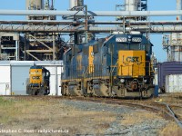 The view at the CSX home shop for the Sarnia division. Y120's power parked by the station framed in industrial pipelines waiting to be called by the night job. In the background at right is an old boxcar on the RIP track used for MOW storage, and at left is 2757 parked by what remains of the Erie & Huron Roundhouse. While the building may look modern, it's far from it. The modern retractable bay door replaced original wooden doors around 2005 and steel clad covers what remains of a turn of the 19th century brick building. From the sides and rear the brick remains uncovered complete with C&O logo, but good luck getting permission to go back there now. As I stood on Clifford St, a public road to get this shot Security was waving at me to leave - but they were too damn lazy to come talk to me where I would have told them to piss off. :)
