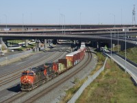 A 113-car CN 527 has CN 2314 & CN 2139 for power as it emerges from the newly reconstructed Turcot interchange on a sunny fall day. Up front are two flatcars with aluminum ingots, a type of commodity not normally seen on this train.