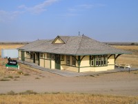 Here's a place that sure is off the beaten path. No highway runs thru it.
Empress was named for Queen Victoria, of all people, as she was also the Empress of India. The community was established in 1913, as the railroad thru here between Bassano, AB and Swift Current, SK had chosen this location as a major division point. At one time, a yard, water tower, roundhouse and turntable were in the plan. The number of yard buildings were eventually taken up, as traffic very light, and the track was removed around 1990 running east, and approximately 1998 running west. Nothing is left but this beautiful "one of a kind in Alberta" station, which was built in 1914 and now serves as a museum for this 'town' of 135. When you look at the overall view of this structure, with the barren lands surrounding it; one would think this takes on the appearance of a plastic model all ready for the layout.