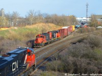 L551 is coming off the Milton Town Spur after working Taiga Building Products as a westbound passes on the Halton sub. The Milton town spur is all that remains of the former Hamilton and Northwestern Railway alignment (Milton sub prior to 1964). <a href=http://www.railpictures.ca/?attachment_id=38332 target=_blank> Here's a pic with the station intact by Bill Thomson</a>