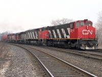 As most of you on this site are probably tired of hearing by now; locomotive variety was much more impressive in past years than it is today. There were periods in which anything seemed to show up. This image is not an extreme example, but it is interesting.
This is a Mac Yd to Fort Erie train:  CN 3542, 2117, 9307, 9316 and 9624 the power.
The 3542 was renumbered from 2542; sold to Hudsons Bay RR. The CN 2117, BBD HR616 was one of 20 behemoths from Bombardier, so unreliable they were all pulled from the roster by 1998; and this unit was peddled off to NRE.
The 9307 and 9316, GP40s, one went to RMGX and the second to Roberval & Saguenay as their #65. And the trailing unit, 9624, a GP40-2 (W)?  Well, it got itself retired in 2001.