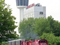 About 6 years before all the track in downtown Niagara Falls was torn up for a Casino and other atrocities, we see CP 4211 leading 8248 and 4233 past the Minolta Tower on its way to the USA.  This is June, the weather is great, and the real fun begins when everyone starts cursing and bitching when the train fouls the Clifton Hill tourist area. I was probably the only one who enjoyed it. Never-the-less, no matter what it was like, traffic was so bad in the falls during tourist season (almost all year) that it wasn't worth the effort to try and get ahead of this train and catch it again before it made the bridge. All three locomotives on this train are now off the roster; and the two MLWs have gone to where sometimes I wish I could. The Apache Railroad in sunny Arizona!!
It would be interesting to revisit this spot and check the view today. It is now so full of hotels it would look more like downtown Toronto than little ol' Niagara.