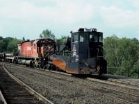 Was at the Parry Sound CP station on a rather hot afternoon for a spell; all quiet. Waiting a work train coming up from MacTier. Here it is rounding the curve toward the station having just crossed the Parry Sound trestle. Do not recall where it was headed. CP 4742 the power, with an old (1960)Spreader leading, #402881. Rather tired looking thing. The Canadian Trackside Guide states this relic is still around, now assigned to Binghamton !