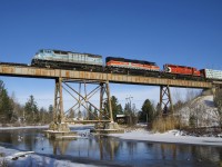 A pair of barns (CMQ 9020 and CMQ 9017) have been on home turf during the past week, going back and forth between Maine on Montreal on CP 250/251. The presence of CP 6018 last though shows that things have changed, with CP now having taken this line back. Here CP 251 crosses the trestle at Eastman with an 81-car train that was taxing the power. A bit earlier they had told the RTC that they were only doing 12-13 mph (track speed here is currently 25 mph).