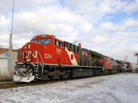 After entering the Montreal area before sunrise as the DPU on CN 322, military tribute unit CN 3233 is seen leading a short CN 527 through St-Henri, with CN 2504 & CN 2294 trailing.