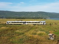 The Charlevoix Railway (Chemin de fer du Charlevoix) operated arguably the most spectacular passenger rail line in Eastern Canada between Montmorency Falls near Quebec City and La Malbaie. The 90-mile line clings to the mountainous north shore of the St-Lawrence River and includes 2 short tunnels. The main station and maintenance facilities were located at Baie-St-Paul. This photo shows the afternoon train to Montmorency Falls about a mile out from Baie-St-Paul. The consist is an ex-Deustche Bahn multiple unit diesel (Baureihe 628 series). The line hasn't carried freight traffic for many years. We'll see if post-COVID tourism is enough to keep it going.