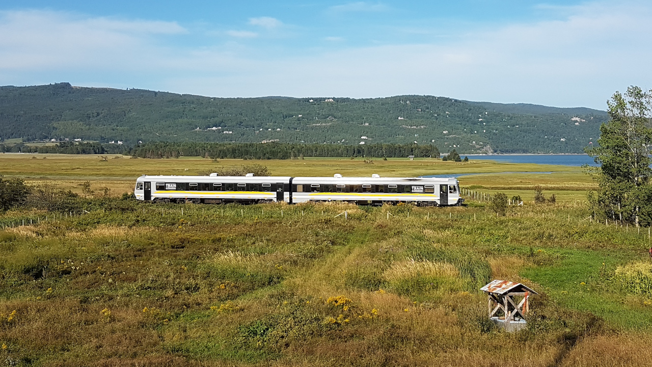 The Charlevoix Railway (Chemin de fer du Charlevoix) operated arguably the most spectacular passenger rail line in Eastern Canada between Montmorency Falls near Quebec City and La Malbaie. The 90-mile line clings to the mountainous north shore of the St-Lawrence River and includes 2 short tunnels. The main station and maintenance facilities were located at Baie-St-Paul. This photo shows the afternoon train to Montmorency Falls about a mile out from Baie-St-Paul. The consist is an ex-Deustche Bahn multiple unit diesel (Baureihe 628 series). The line hasn't carried freight traffic for many years. We'll see if post-COVID tourism is enough to keep it going.