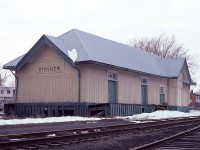 Stayner, Ontario. Former CN station.  The Ontario, Simcoe & Huron Railway came thru here back in 1860 on its way to the Georgian Bay terminus at Collingwood.  Stayner became a popular and busy stop along the way on this line from Barrie; as agriculture and lumbering were very big here.
The last scheduled train stopped in town on July 2, 1960; and powered by GO 9861 of all engines. After that, the station closed and remained so until the Stayner Co-Op purchased it and the land and used the building for storage, as you see here.
In 1985 the building was sold to the Cranberry Golf Club of nearby Collingwood. The structure was loaded up and moved by truck to the Club, where it remains today as a completely renovated pro-shop, kitchen and dining area.
It retains its 'station' appearance, but inside, well, just another building.