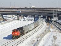 Empty grain train CN 875 is emerging from the newly rebuilt Turcot interchange with new grain cars up front. This 198-car train has CN 8874 up front, CN 2930 mid-train and CN 2334 on the tail end.