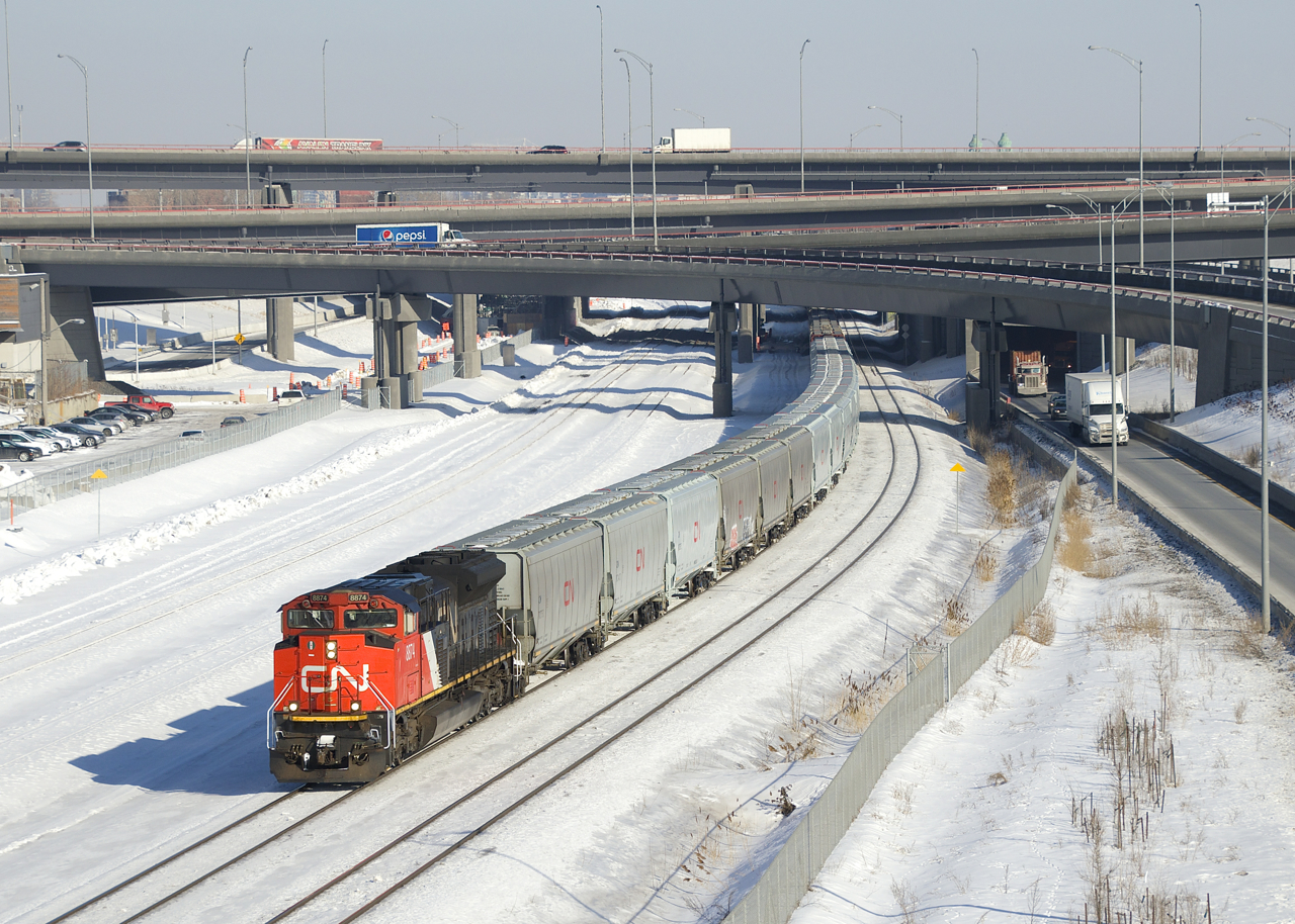 Empty grain train CN 875 is emerging from the newly rebuilt Turcot interchange with new grain cars up front. This 198-car train has CN 8874 up front, CN 2930 mid-train and CN 2334 on the tail end.