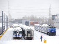 EXO equipment is seen in the Pointe-Saint-Charles Maintenance Centre as light snow falls.