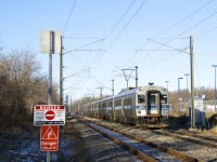 On the third to last day of service, we see southbound EXO 936 approaching Roxboro-Pierrefonds Station on the main. Two minutes later, northbound EXO 933 will pass on the siding at left. As the sign at left warns of, this line is electrified with a 25000 volt power source. Yesterday was the end of the line for the electric Deux-Montagnes line. Already truncated so that trains terminate at Bois-Franc Station since this past spring (instead of going all the way to downtown Montreal via the Mount Royal tunnel), the rest of the line is now shut down and all the tracks and infrastructure will be torn up. It will be replaced by the controversial REM light rail project, which is only set to be in service here during Q4 2024. 