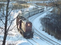 This looks like a frigid afternoon. Much like the day I am posting this.  Judging by the low sun in the western sky, I am going with the idea this is train #86, which was due in at Aldershot at 1614. But do not know for sure.
A pair of old RS-18s, 3110 and 3106 are seen from the railfans hillside chugging downgrade into Bayivew Jct. Not exactly classy, but they got the job done.