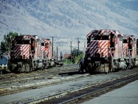  I loved the broad white strips on the end of the CP locomotives back in the day, and as well I was a fan of
the SD40s; as their styling and the fact many often were needed on the head end compared to the behemoths of today.....and out west in Kamloops I certainly got my fill when visiting back in 1975. Busy place, beautiful country.
Here we see 5593, 5605 and 5821, 5812 at work in the yard.