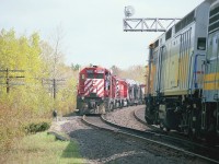 Have to admit I really got caught here. Raced over from the CP station to the Isabella St crossing as the freight was moving slow. Looked like a great shot until I saw the s/b Toronto section of the Canadian coming. Didn't know what else to do, so stayed put. There was no shot from the other side of the track. So, this is what I get: CP 5502, 5519 and 5738 meets VIA 6407, 6635 and 6504 as #10 heading south.  The signal and siding have long been removed.