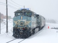 Thick snow is falling as CEFX 1002 brings up the rear of CP 112. After yarding the intermodal portion of its train in Lachine IMS Yard, the head end and mid-train power went light to pick up autoracks and grain cars from the tail end of the train, which had been left on track three of the Vaudreuil Sub.