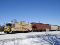 Once a common sight, a wave from a caboose is not something you'll see often these days. With the Pointe St-Charles switcher in Montreal now assigned a caboose for long backup moves, it can happen again when you get lucky. Here a crewmember waves as the train heads towards the Port of Montreal after shoving out of the yard as they pass MP 1.76 of the Montreal SUb. This van is not in great shape, but it is back home, as it was built by CN in their Pointe St-Charles shop in Montreal (now demolished).