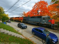 Roll on: The melodic bass of three turbocharged 6-motors rolls alongside kent on the Guelph subdivision while a pedestrian rolls his bicycle toward downtown.
<br><br>
Pulling one out from my crates - this is one of my favourite places in Guelph - I liked it so much I lived around here for 2 years in the early 2000's. I came across this angle while studying what I could do in the fall with GEXR on the ropes, soon to be history on the Guelph sub and I came up with this. Just as I took the photo, not only did the bike guy walk into the frame just at the right time, the hogger found me on the hillslde and gives me a slight wave from the cab. The SP nose of SD45-T2 3054 really stands out in this wide angle view.