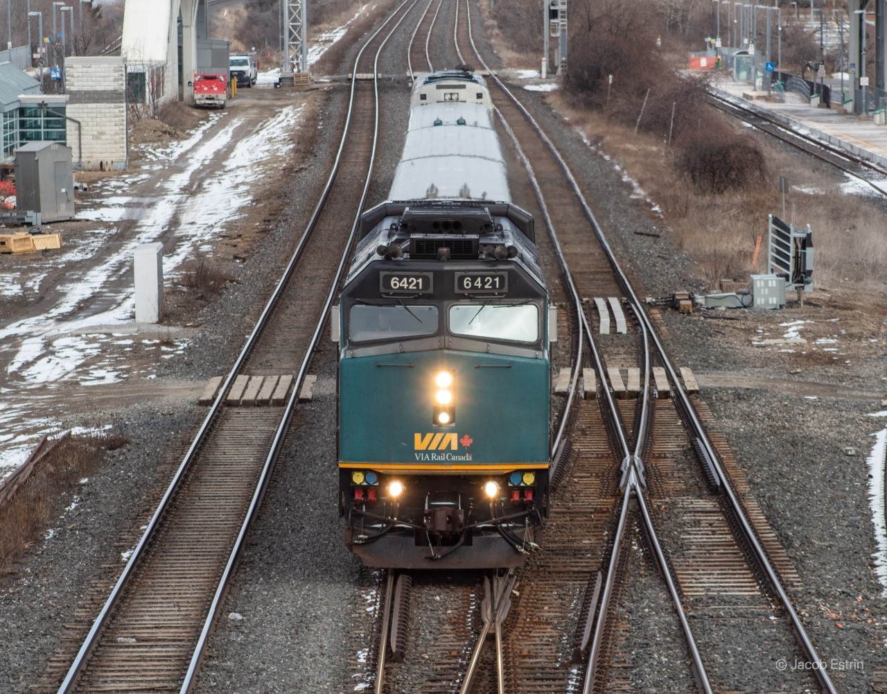 VIA Engine 6421 West seen passing through Liverpool Jct on a cloudy afternoon.