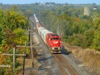 A nice after work train, about to duck under highway 6, CP 255 with a trio of EMD's is giving 'er for track speed to London. In the background is the bucolic Puslinch countryside.