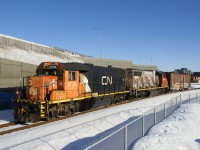 The Pointe St-Charles switcher has a single boxcar for Kruger on the Turcot Holding Spur as it approaches the level crossing at Notre-Dame Street. At left is part of the recently finished and reconstructed Turcot interchange. Barely visible at right is the leader of grain train CN 878, temporarily stopped on the Montreal Sub.